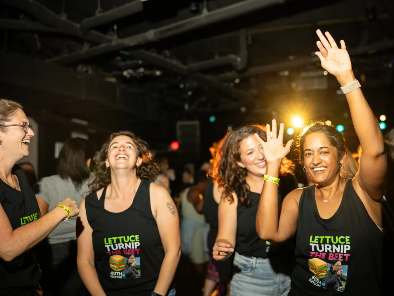 Lindsey Falasca (left) dances with her friends in matching shirts as they celebrate her 40th birthday.