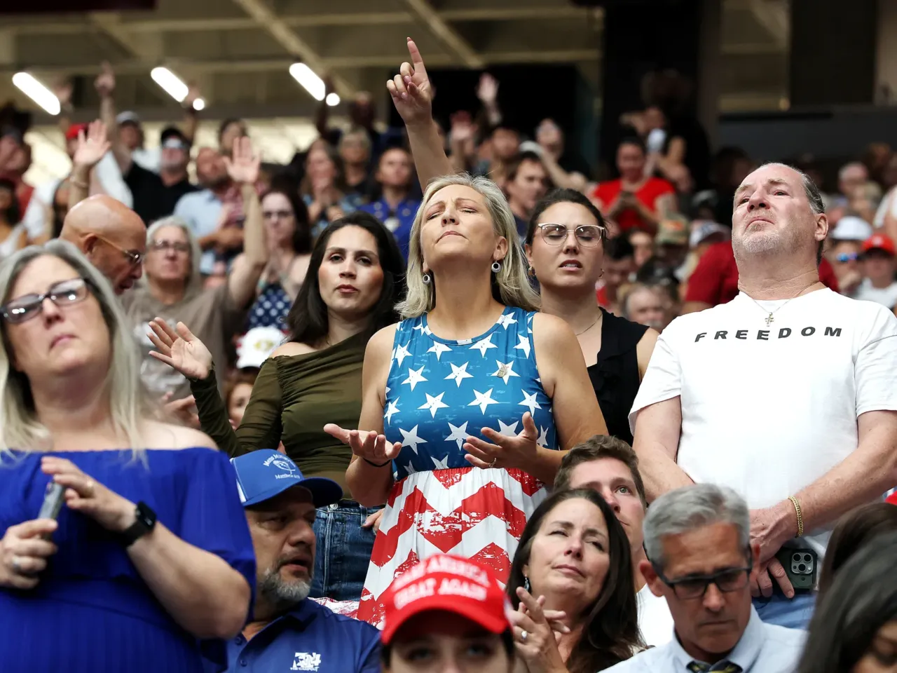 Attendees await the start of the memorial service for political activist Charlie Kirk at State Farm Stadium on Sunday in Glendale, Ariz.