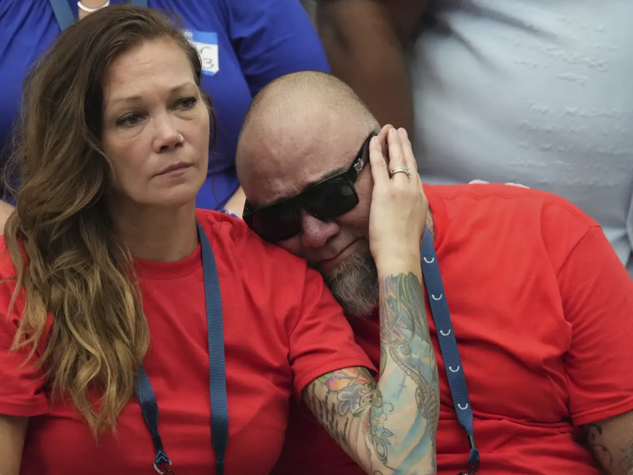 Supporters comfort each other prior to the start of the memorial.