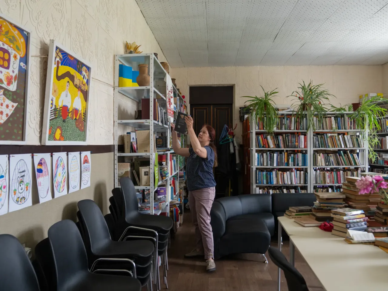 How to reintegrate over a million veterans? Groups in Ukraine are working on it 9 A librarian in Hubynykha, a village where the East SOS trainings have been rolling out, pulls books that they've added to the library to help the community understand the veteran experience.