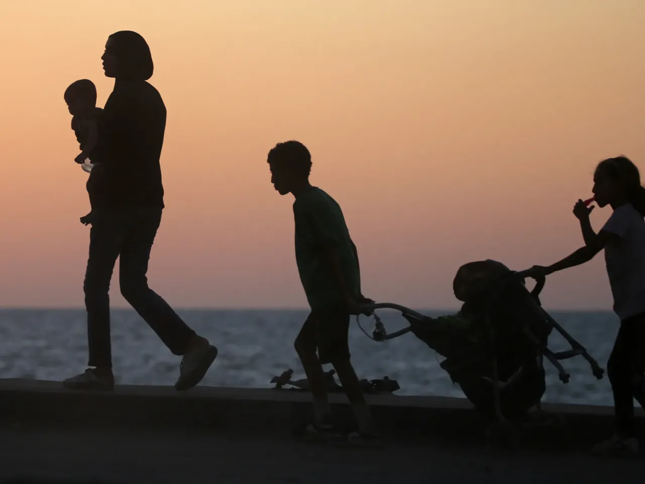 A question of intent: Is what's happening in Gaza genocide? 3 Displaced Palestinians carry their belongings along a road in the Nuseirat refugee camp area in central Gaza on Sept. 20 of this year, as Israel advanced its ground offensive toward Gaza City.