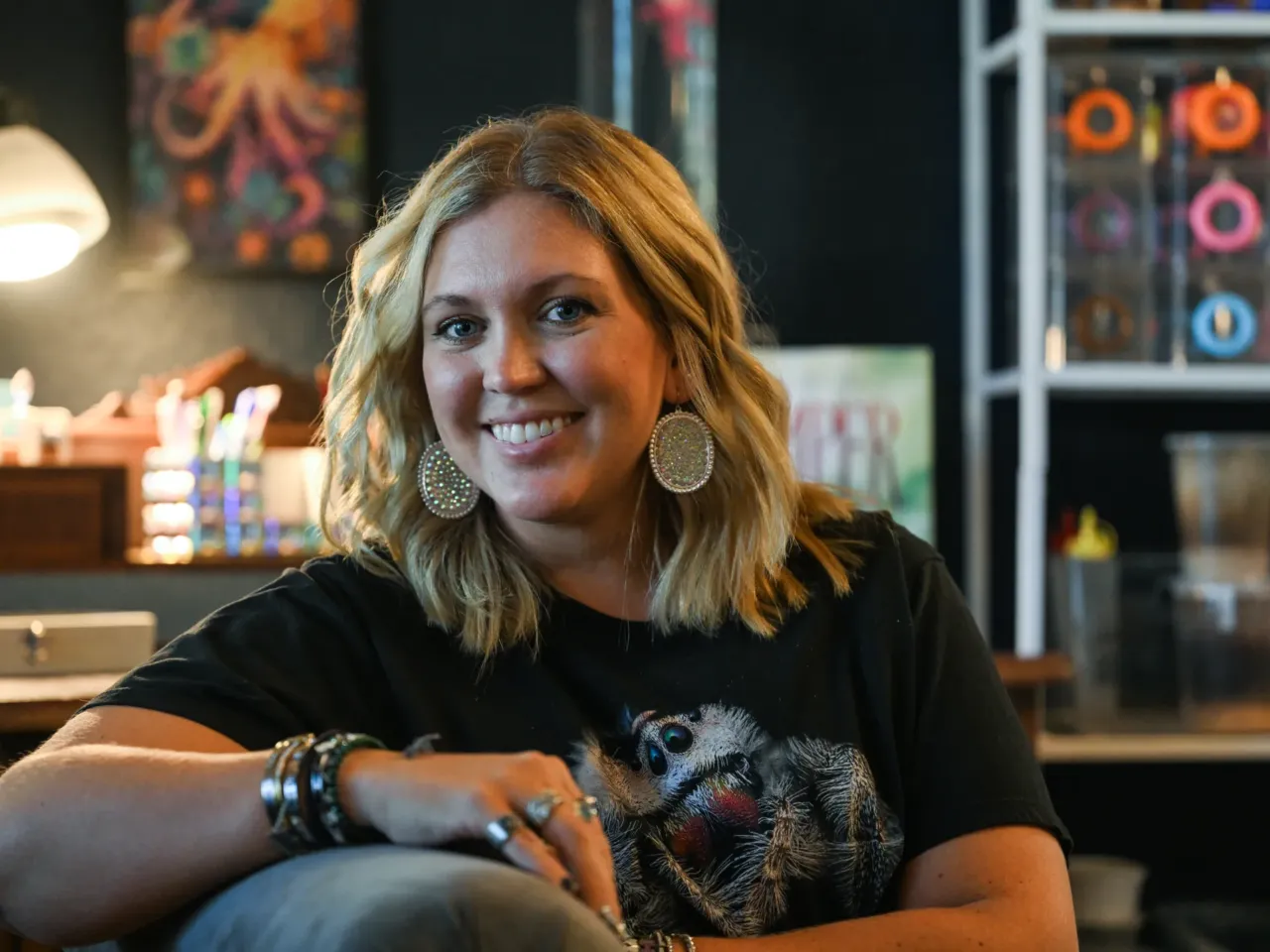 Heather Mulligan holds one of her jumping spiders in Surprise, Arizona, on Sept. 15, 2025.