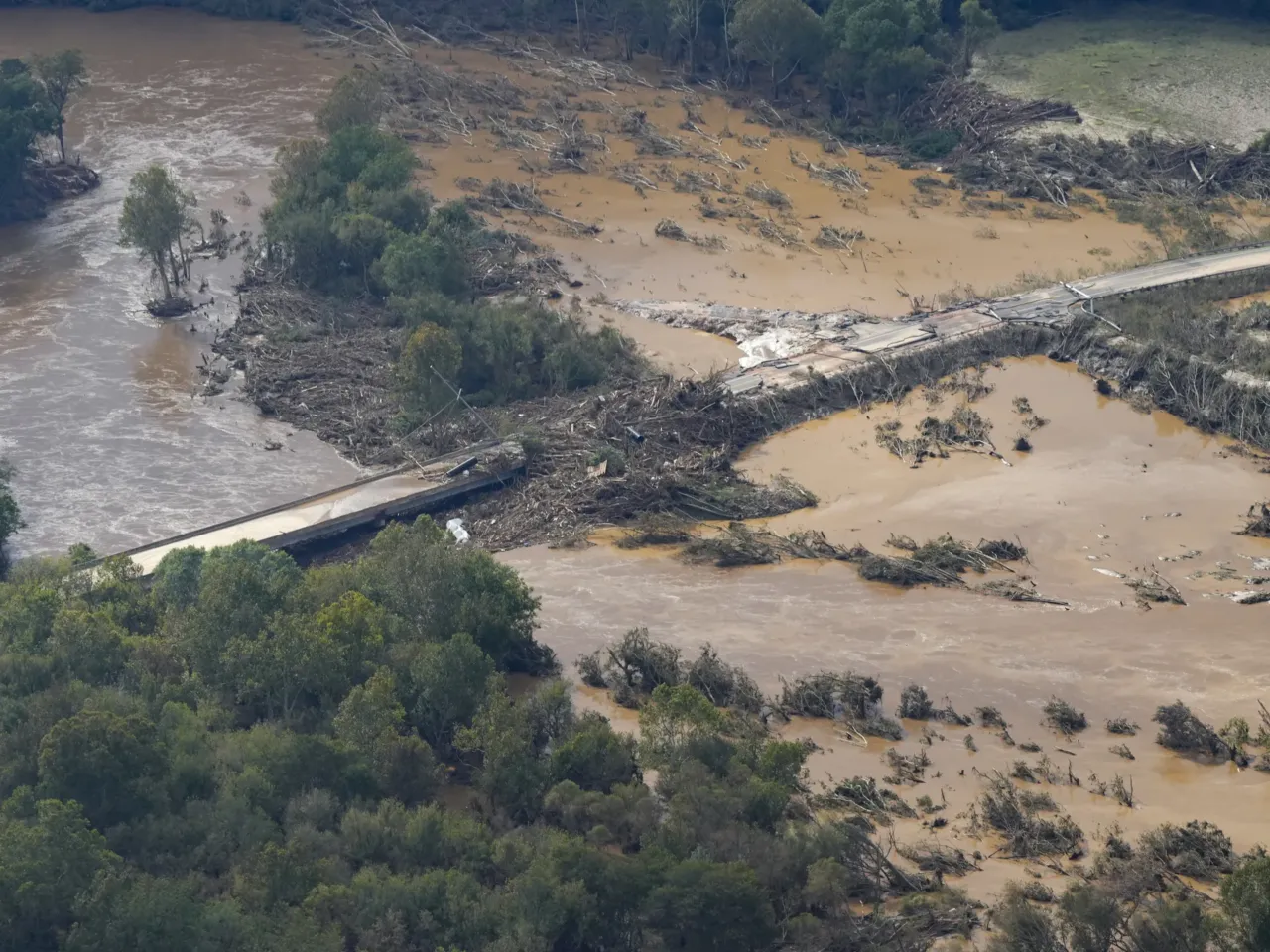 A year after Helene, a group of raft guides embarks on a river clean-up mission 1 An aerial view of a damaged bridge and flooding in the aftermath of Hurricane Helene is seen along the Nolichucky River, Sept. 28, 2024, in Greene County, Tenn.