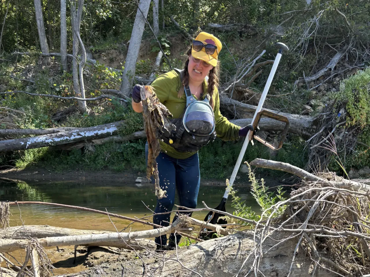 A year after Helene, a group of raft guides embarks on a river clean-up mission 2 Raft guide Amelia Taylor pulls household debris from thick brushwood along the banks of the Nolichucky River.