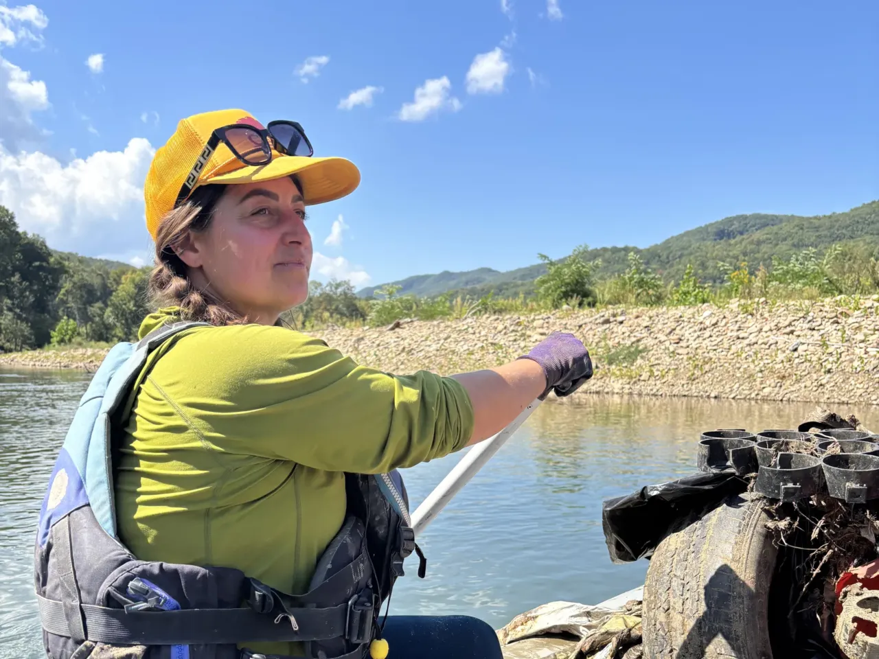 A year after Helene, a group of raft guides embarks on a river clean-up mission 3 Raft guide Amelia Taylor scouts the Nolichucky River rapids on a raft piled high with garbage.