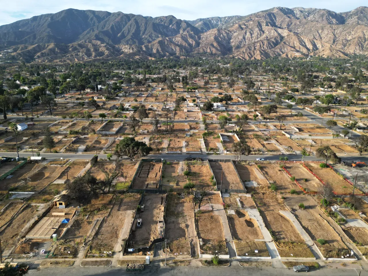 Hours before the Eaton fire, distribution lines failed and fire started in Altadena 1 An aerial view of cleared residential lots, with the San Gabriel Mountains in the background, in Altadena on Aug. 21, just over six months after the Eaton Fire, which claimed 19 lives and destroyed more than 9,000 structures.