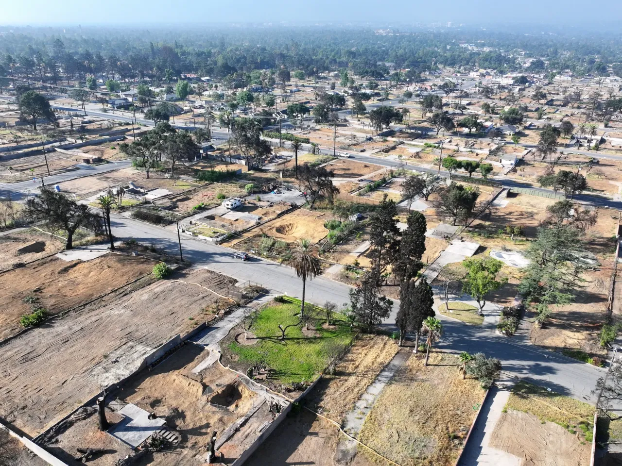 5 takeaways from NPR's investigation into the role of distribution lines in LA fires 2 An aerial view of properties cleared of fire debris that burned in the Eaton Fire seen on July 7, 2025 in Altadena.