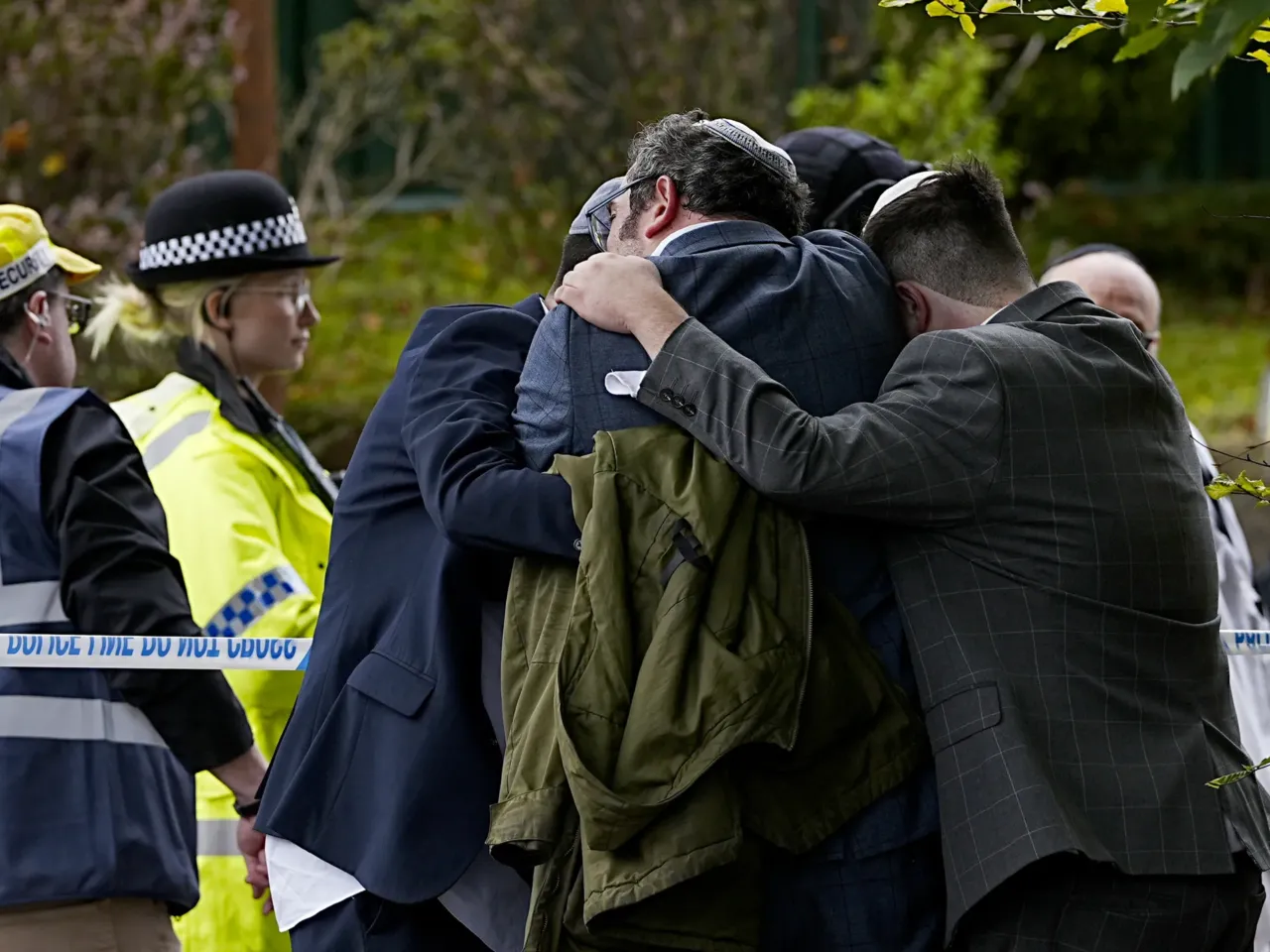 U.K. police have identified the suspected attacker of a Manchester synagogue 1 Members of the Jewish community comfort each other near the Heaton Park Hebrew Congregation synagogue in Crumpsall, Manchester, England, where two people died in an attack Thursday that police have labeled a terrorist incident.