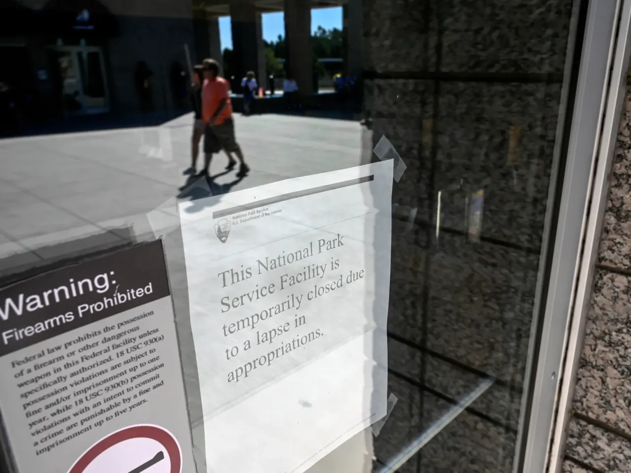Karoline Leavitt says White House must cut spending due to shutdown 1 People can be seen in the reflection of the Information Center front doors along with a closed sign to the center due to the nationwide government shutdown at Mount Rushmore National Memorial, Thursday, Oct. 2, in Keystone, S.D.