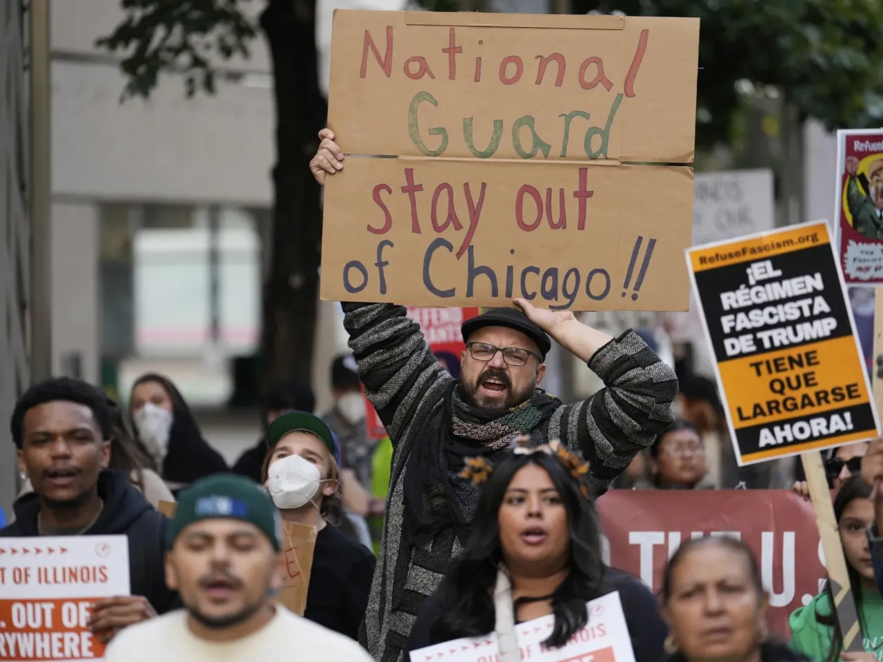 People march during Illinois Coalition for Immigrant & Refugee Rights' "Chicago Says No Trump No Troops" protest Saturday, Sept. 6, in Chicago.