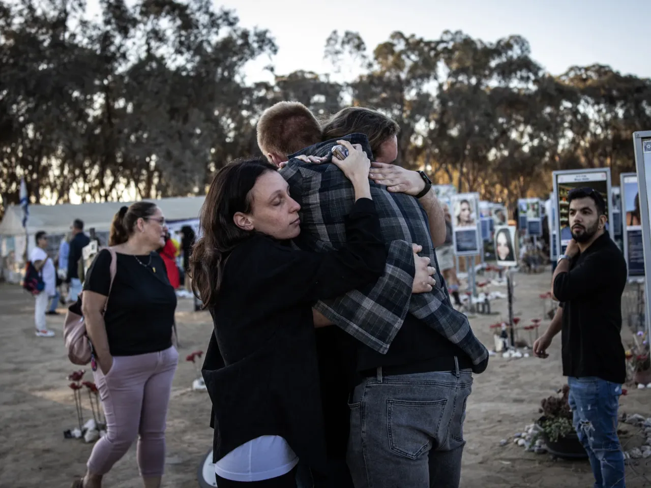 People embrace next to memorials of victims of the Oct. 7, 2023, attacks at the Nova Festival grounds in Reim, in southern Israel, on the second anniversary of the Hamas-led attacks on Tuesday.