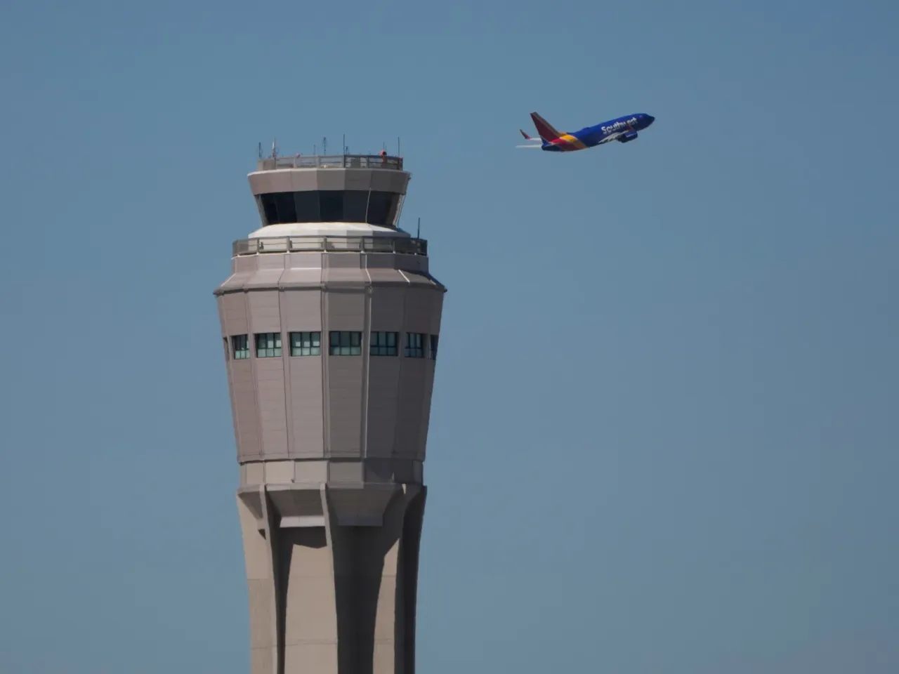 A plane takes off near the air traffic control tower at Harry Reid International Airport, Tuesday, Oct. 7, in Las Vegas.
