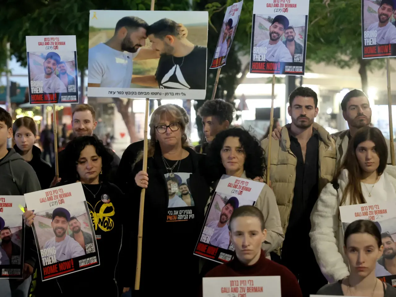 Twins hold portraits of Gali and Ziv Berman, who were taken by Palestinian militants on the Oct. 7 attack and since held hostage in the Gaza Strip, during a rally calling for their release, in the Israeli coastal city of Tel Aviv.