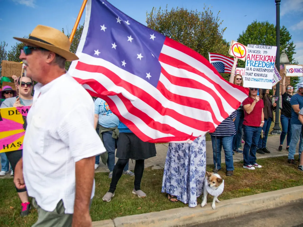 Joe Bondulich carries a flag past the crowd gathered on the side of College Street in Macon, GA. "This is the flag the last time we fought kings. This is original 13 stars and 13 stripes," Bondulich said,  "So this is the original Revolution flag."