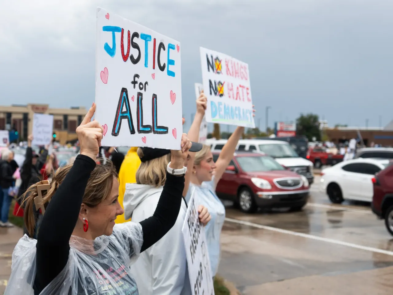 Amy Gryder (l) and her daughter, Ella Walther (r), stand outside for the No Kings Protest on Mid Rivers Mall Drive in St. Peter's, MO. Walther says when it comes to civil liberties that goes for everybody. "This isn't a right or left issue. This is a right or wrong issue," Walther said. "What's happening right now impacts everyone."'