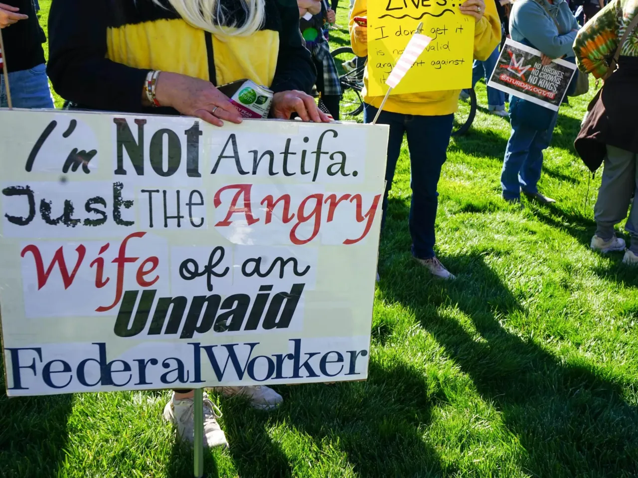 A protestor holds a sign at a No Kings protest in Salt Lake City, UT.