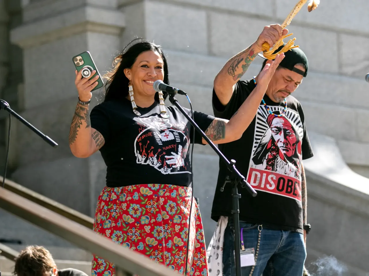 Raven Payment (l) andTyler Crazybear (r) speak as protesters fill the Colorado State Capitol in Denver.