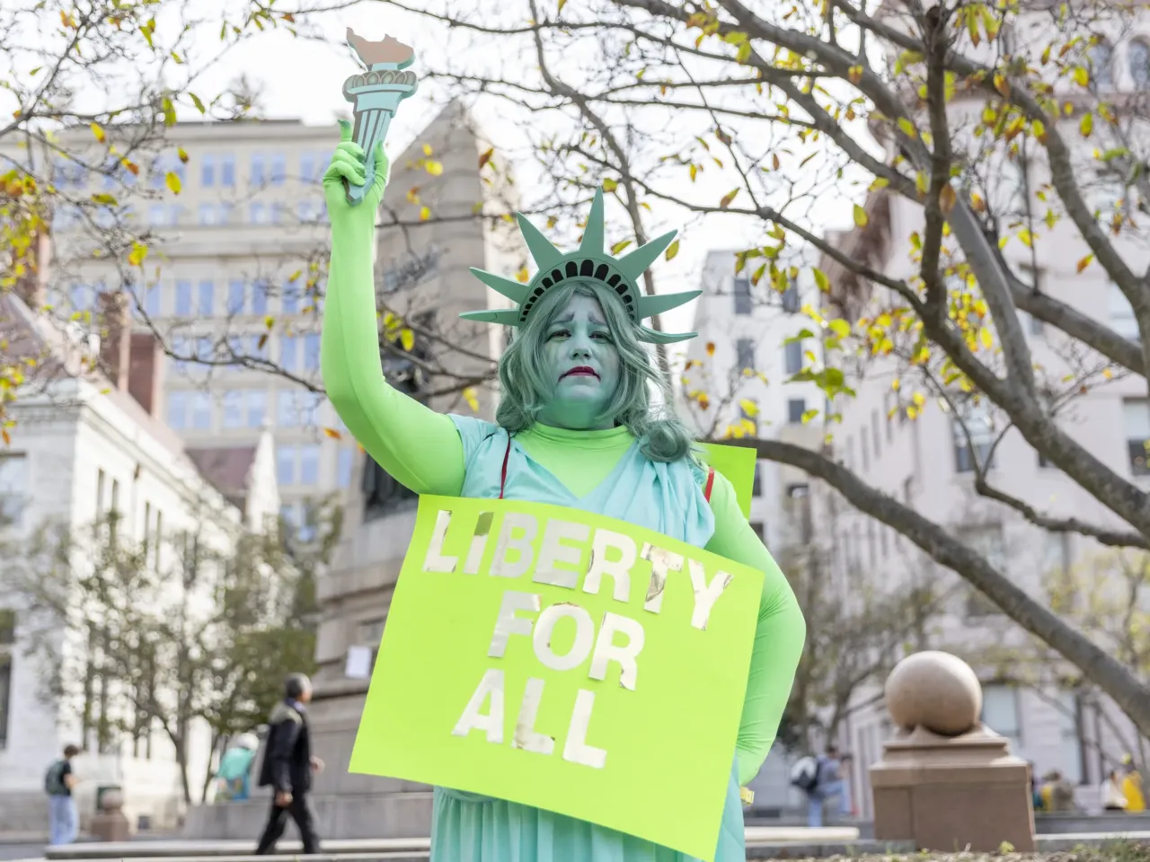Tara Reel, dressed as the "grieving" Statue of Liberty, a recent federal worker who took the deferred resignation program. Large crowds gathered in downtown Washington D.C. on Oct 18, 2025 for the "No Kings" rally.