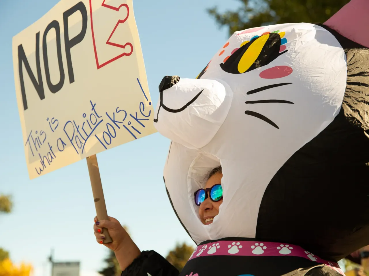 Jen Sandoval aka "Día de los Meow-tos" attends the "No Kings" protest in Prineville, Ore., on Oct. 18, 2025. Sandoval, 54, who is Mexican-American says she's protesting ICE detentions and deportations.