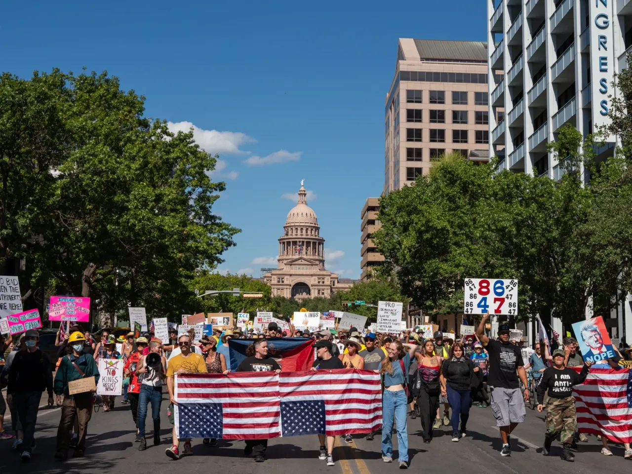 Protestors chant while marching down Congress Avenue during the "No Kings" Protest in Austin, Texas.