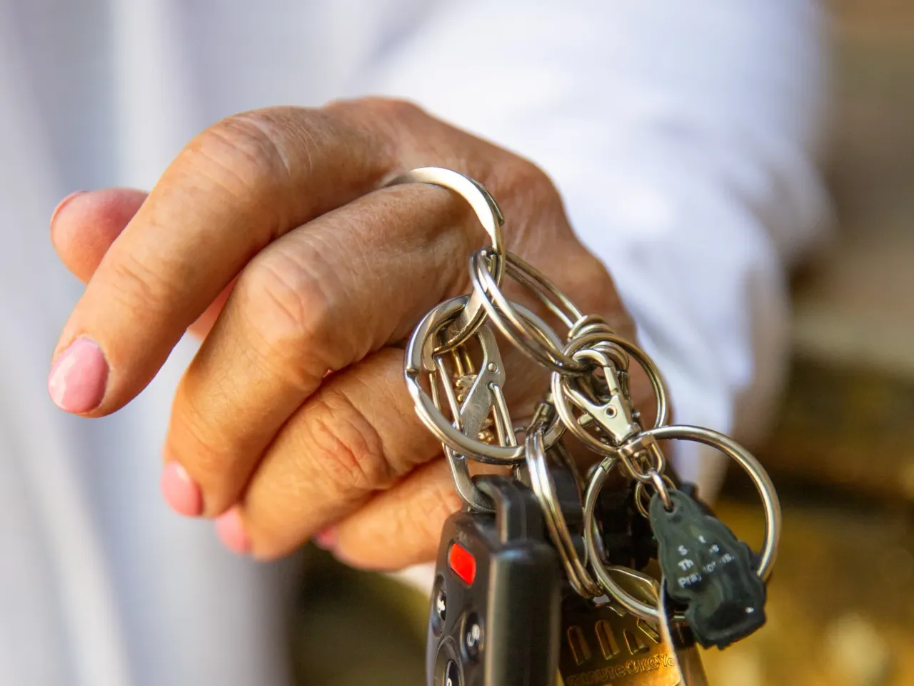 Your credit history could be costing you more to drive 3 Susan Collins holds keys to her car and home.