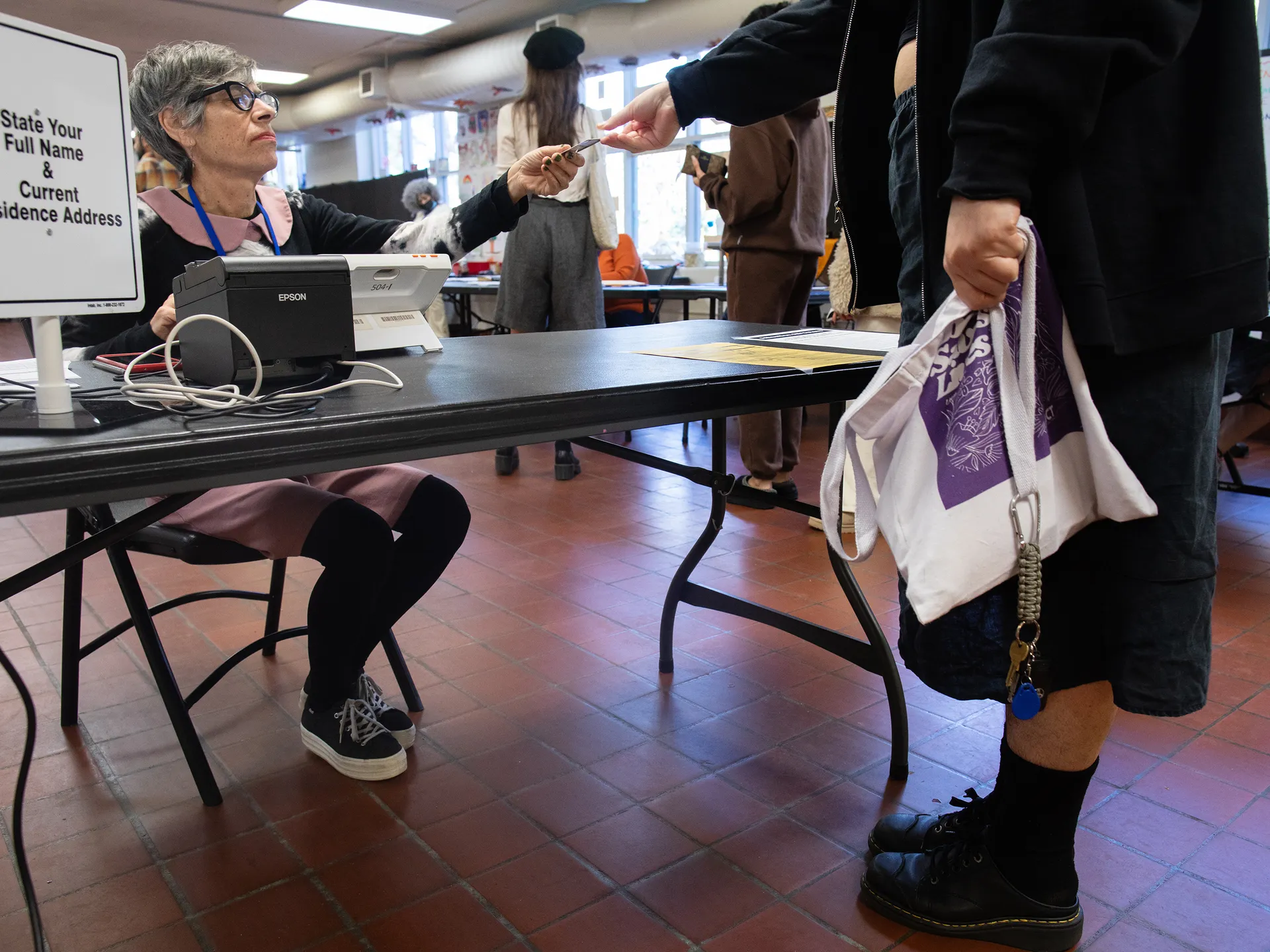 Photo essay: Amid historic election, Virginians long for change 21 Poll worker Samantha Garbus returns a voter's ID at Randolph Community Center in Richmond, Virginia.