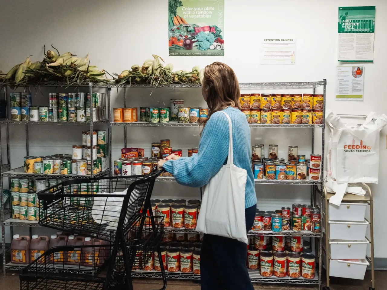 9 strategies to find free or low-cost food when money is tight 2 A resident browses donated food items in the pantry at Feeding South Florida in Pembroke Park, Fla., in October.