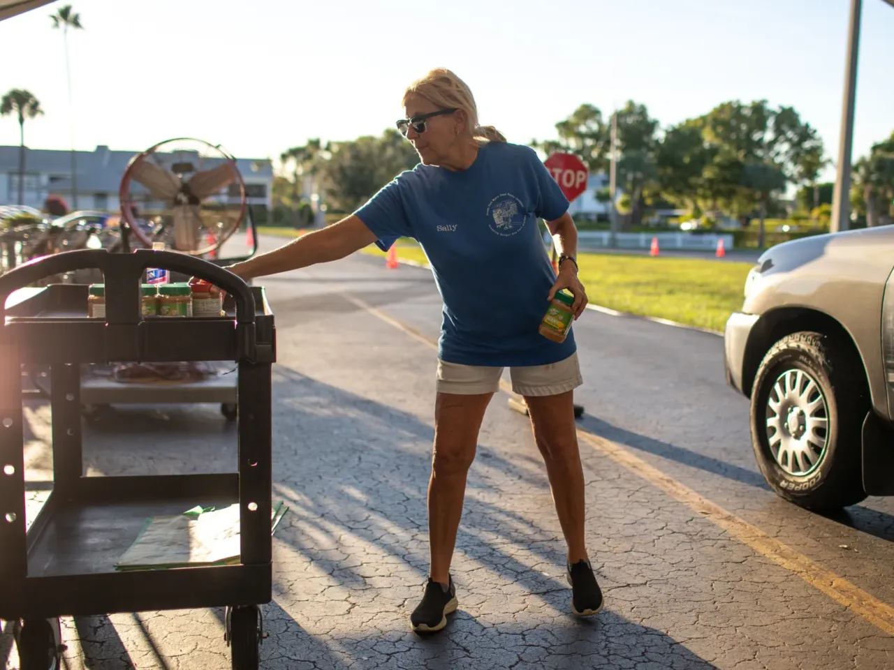 It's harder to get home insurance. That's changing communities across the U.S. 1 Sally Scott hands out food at the South Fort Myers Food Pantry in Florida. The group is seeing more people struggling to afford food amid high housing costs.