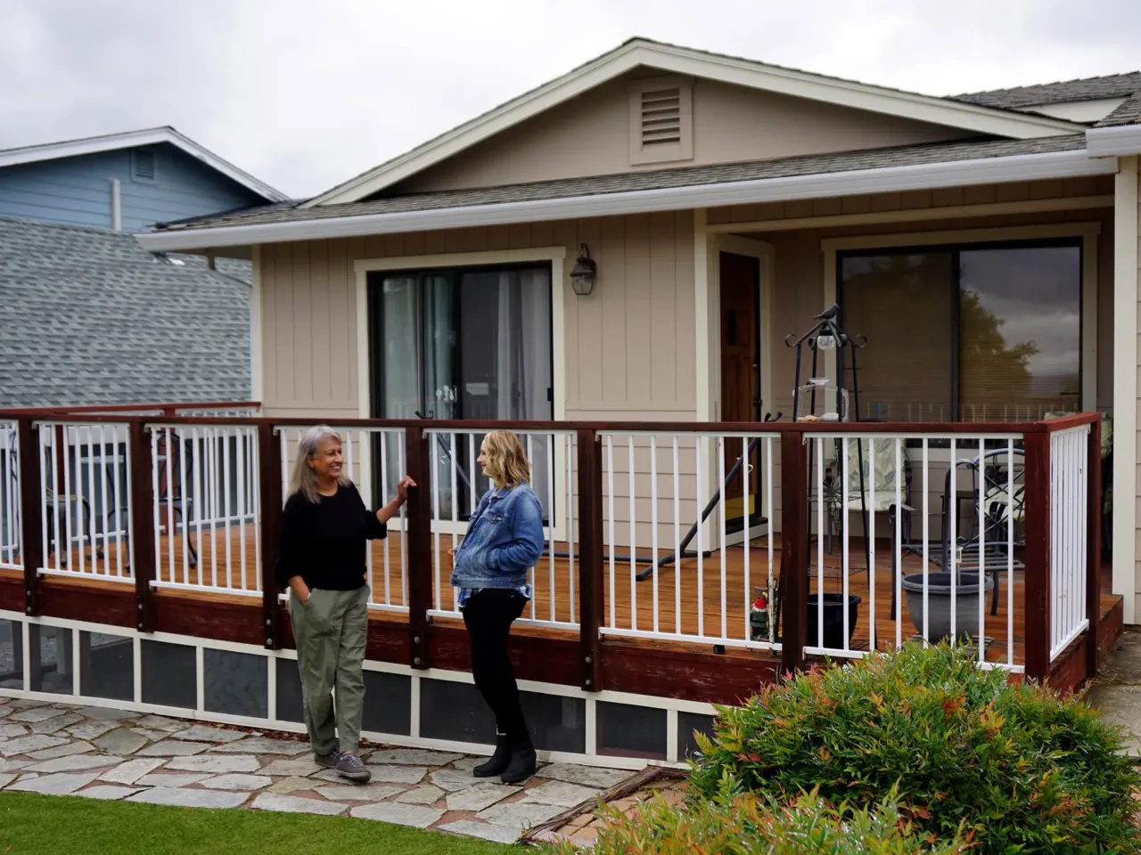 It's harder to get home insurance. That's changing communities across the U.S. 6 Lake County homeowner Penny Sidhu (left) has repeatedly evacuated from wildfires. Her home is getting improvements designed to make it less likely to burn, part of the Lake County Home Hardening Program, where Deanna Fernweh is the program manager.