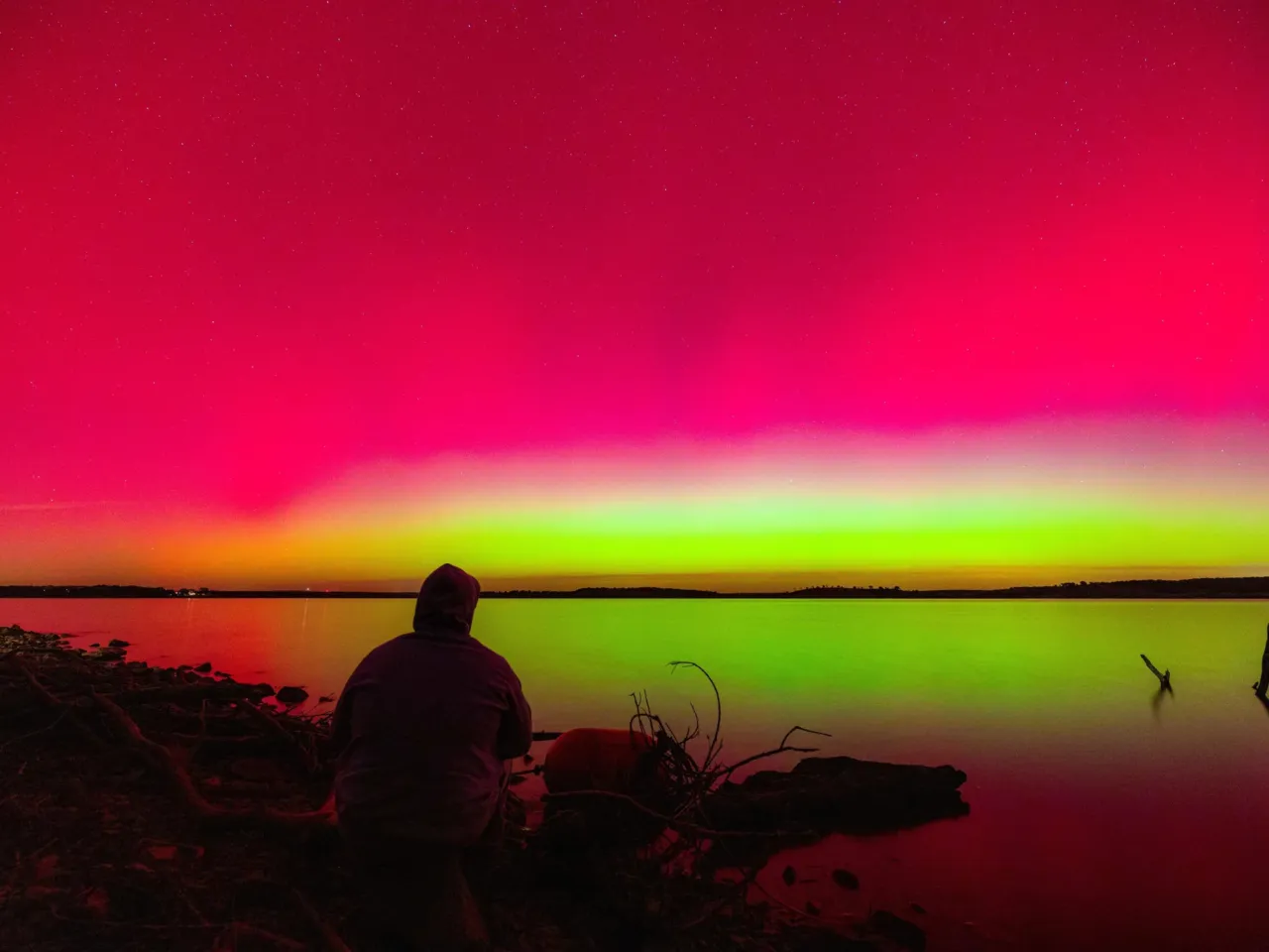 The U.S. saw vivid northern lights as far south as Florida — and more could be coming 4 A person watches the northern lights over Hulah Lake in northern Oklahoma on Tuesday.