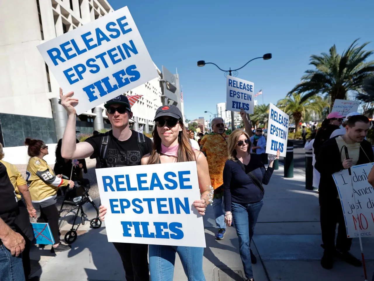 Demonstrators hold signs asking for the release of the Epstein files during a "No Kings" protest in downtown Las Vegas on Oct. 18, 2025.