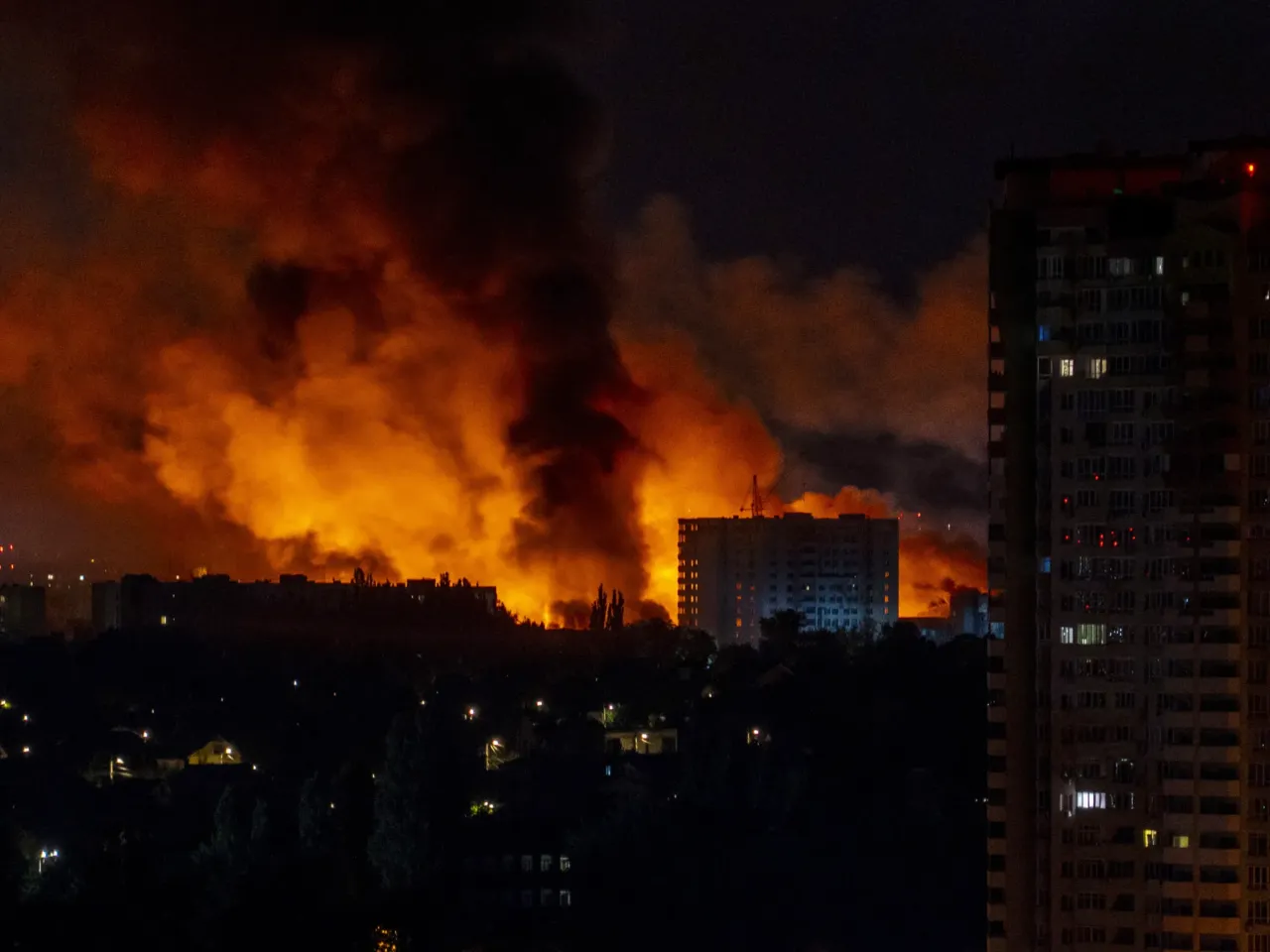Flames and smoke billow from buildings during mass Russian drones and missile strikes on Ukraine's capital in July 2025, amid the Russian invasion of Ukraine.