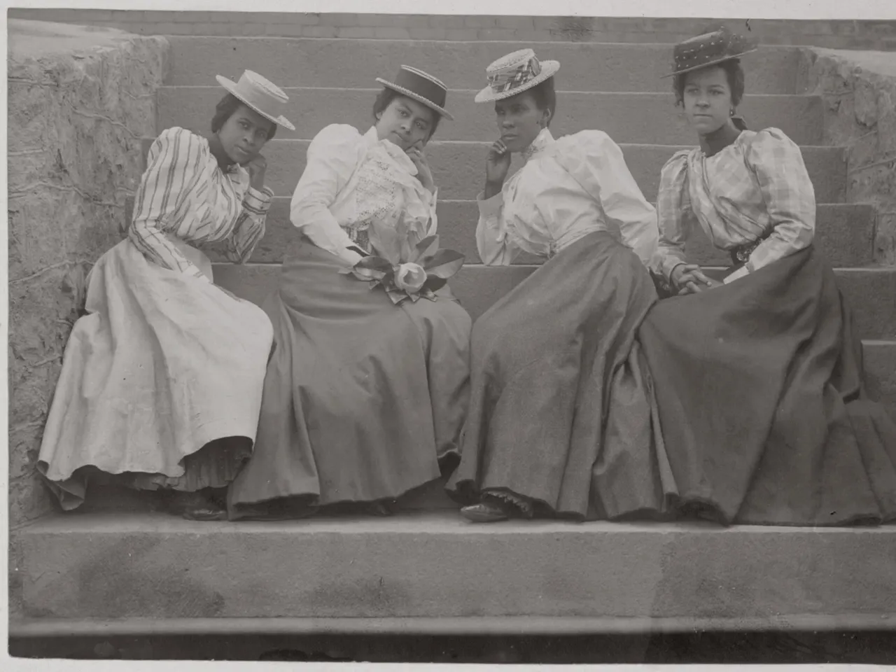 Four African American women sit on the steps of a building at Atlanta University in Georgia in this 1890s photograph by Thomas E. Askew. The image is one of the hundreds included in Reflections in Black, written and edited by scholar and NYU professor Deborah Willis.