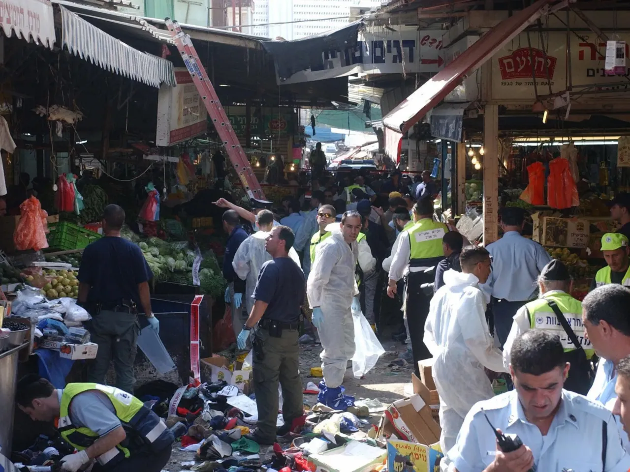 A Palestinian imprisoned for planning a bombing is now a prized novelist, and free 1 Israeli emergency crews work at the scene of a suicide bombing carried out by a Palestinian teenager who blew himself up in a marketplace in Tel Aviv, Israel, on Nov. 1, 2004. Three civilians were killed and more than 30 were wounded in the blast. Bassem Khandaqji was sentenced to life in prison in 2005 for helping plan the bombing. But Israeli authorities released him in October 2025 as part of a ceasefire deal with Hamas.