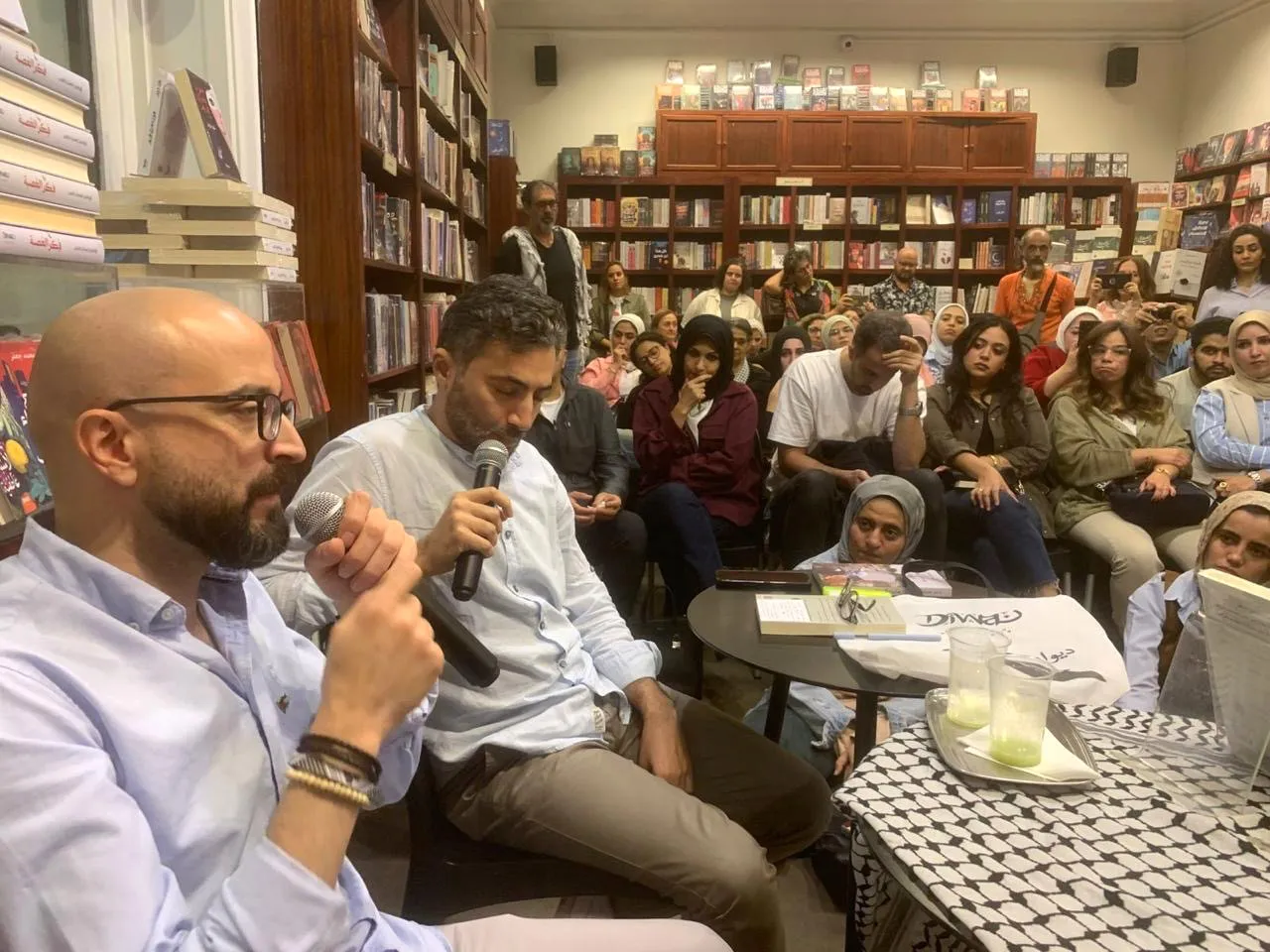 A Palestinian imprisoned for planning a bombing is now a prized novelist, and free 3 Bassem Khandaqji (left) gives a book talk in Cairo after being freed from Israeli prison.