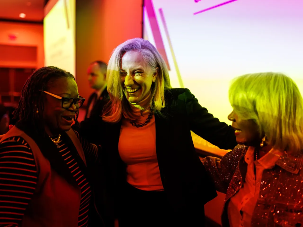 Gov.-elect Abigail Spanberger, center, embraces state Sens. Mamie Locke (D–Hampton) and Louise Lucas (D–Portsmouth), as she arrives for the Senate Finance and Appropriations Committee's annual meeting on Thursday, November 20, 2025 at Radford University.