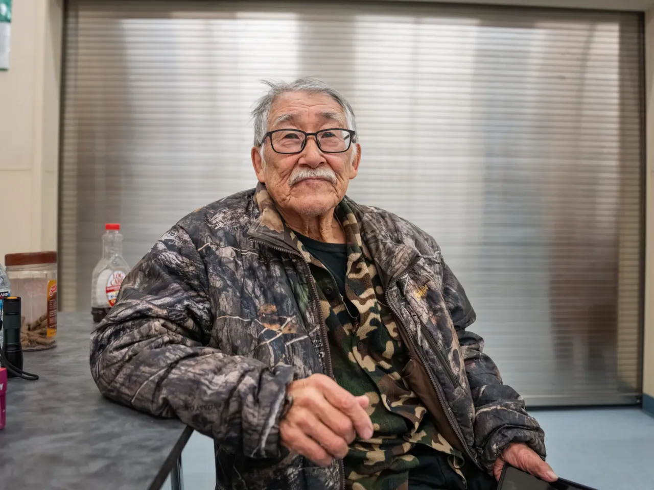 Houses floated away in this Alaska Native village. Now residents want to move 1 Noah Andrew Sr., 74, sits at the Kwigillingok School as he waits for a flight by which to leave his home community.