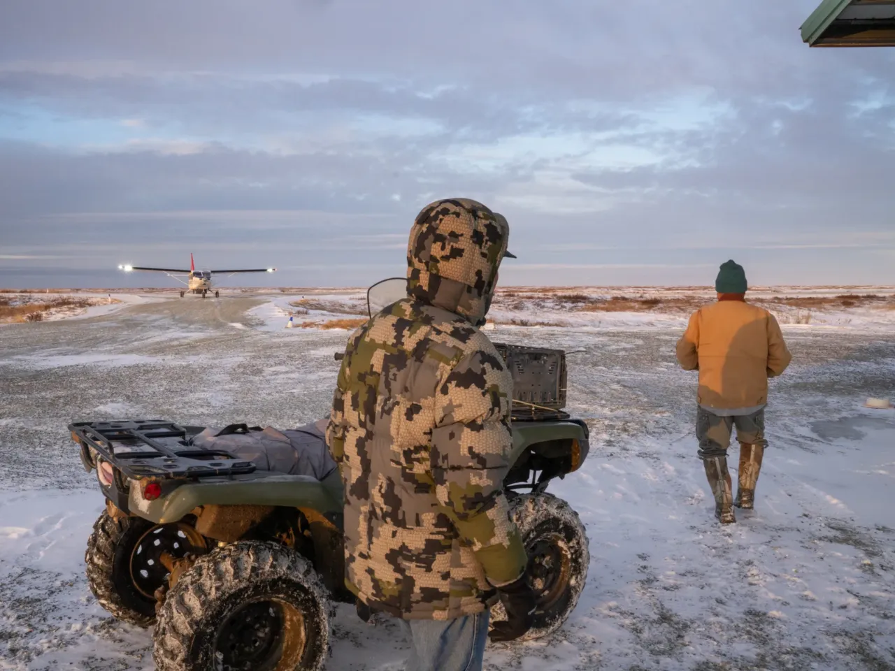 Houses floated away in this Alaska Native village. Now residents want to move 8 People wait for a plane to arrive in Kwigillingok.