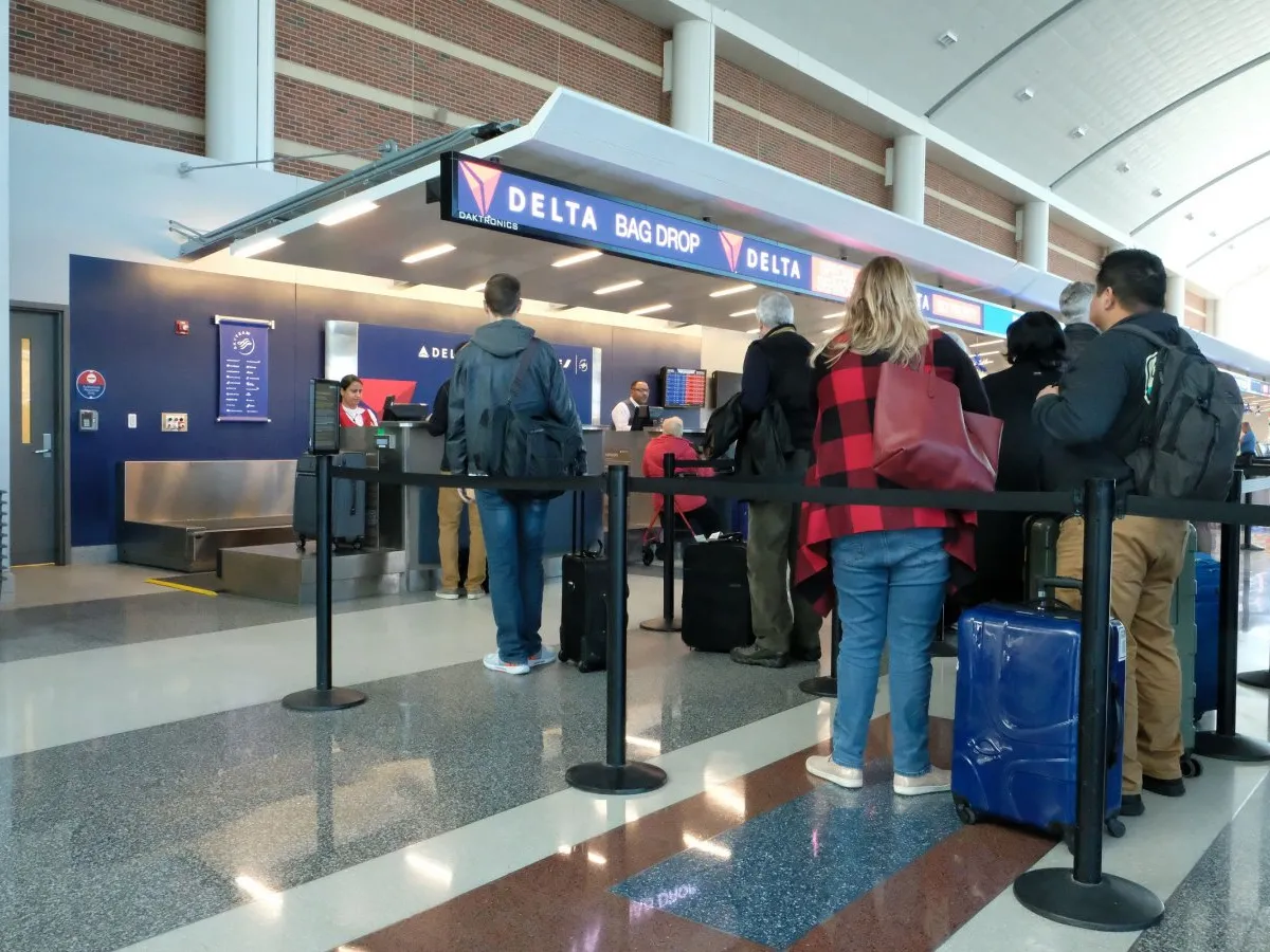 People wait in line at the Delta counter at Richmond International Airport. AAA forecasts nearly 200,000 Virginians will travel via air during the 2025 holiday season. (File photo)