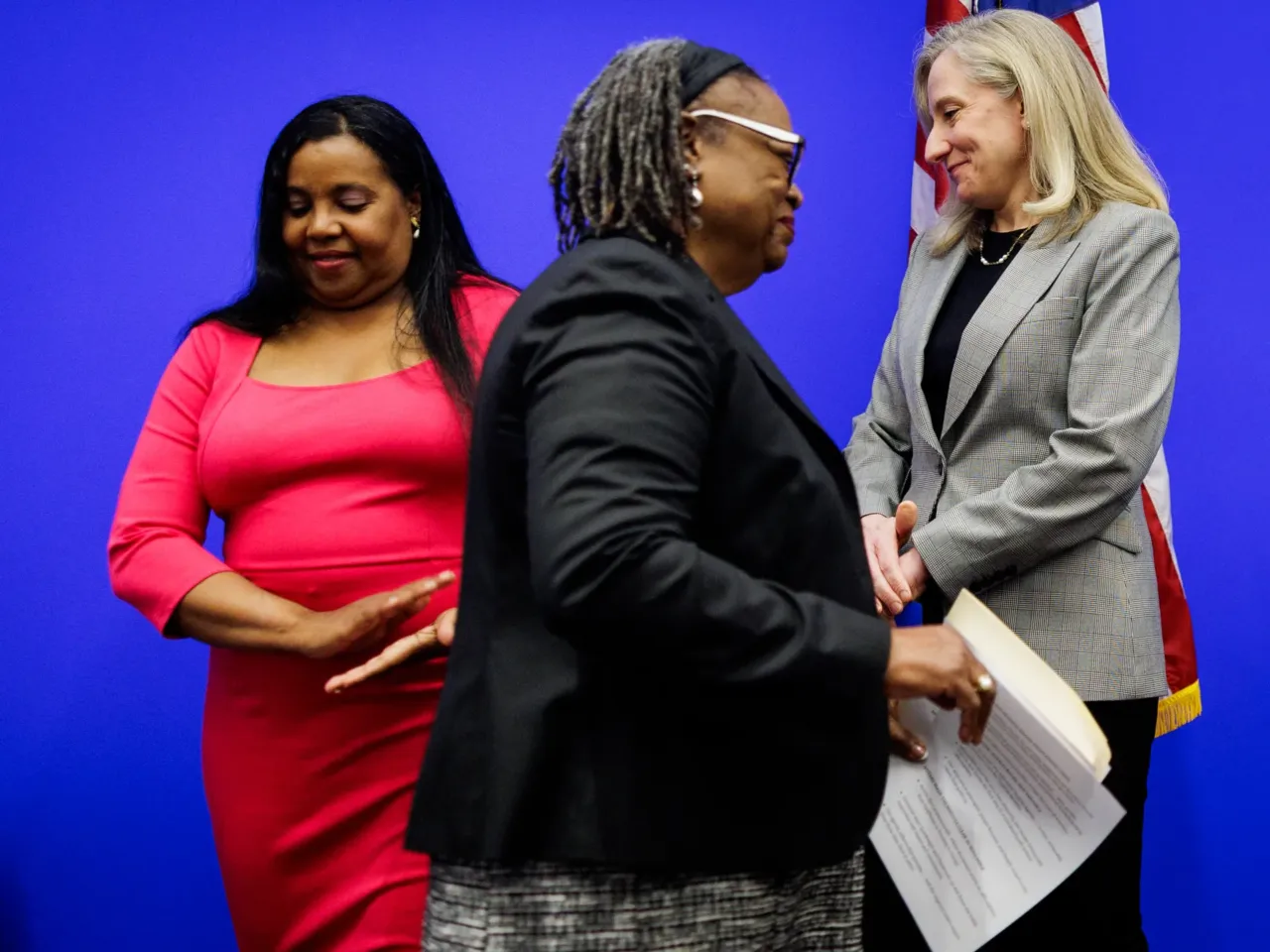 State Sen. Mamie Locke (D–Hampton) makes her way to the podium past Del. Charniele Herring (D–Alexandria) and Gov.-elect Abigail Spanberger during a press conference on Thursday, December 18, 2025 at the General Assembly Building in Richmond.