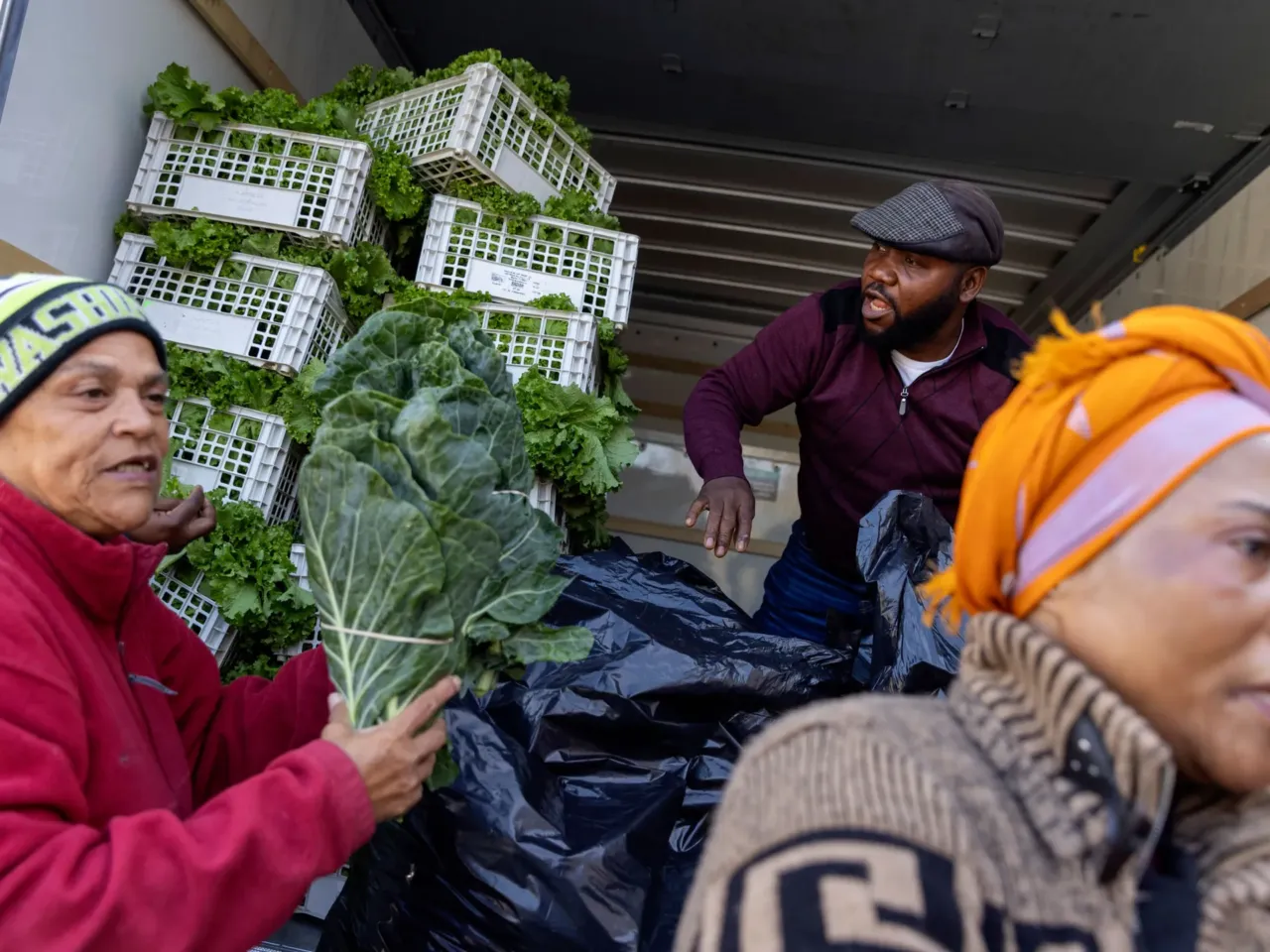 2025: The images that stayed with us 17 Agnes Mwamba (right) and her husband, Joseph (middle), of Agnes Farm and Produce in Brandywine, Md., offload 2,000 pounds of fresh vegetables that they brought to distribute to federal workers in Hyattsville, Md. Grace Herring (left) is a volunteer with No Limits Outreach Ministries, where the Oct. 28 distribution took place.