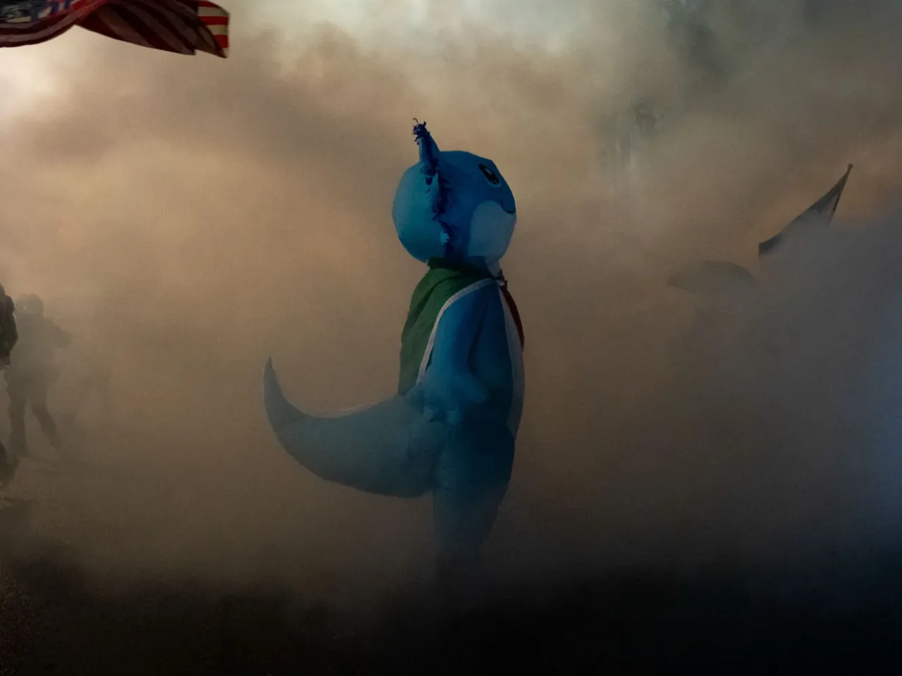 2025: The images that stayed with us 19 A protester in an inflatable axolotl costume wrapped in a Mexican flag navigates a cloud of tear gas outside a U.S. Immigrations and Customs Enforcement building in Portland, Ore., on Oct. 18, where federal officers deployed tear gas, flash-bangs and fired pepper balls.