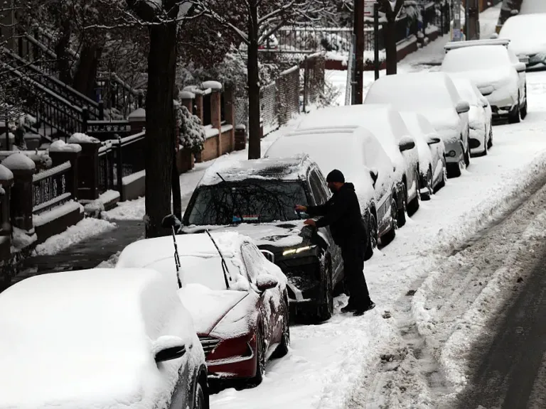 Winter storm brings heavy snow and ice to busy holiday travel weekend