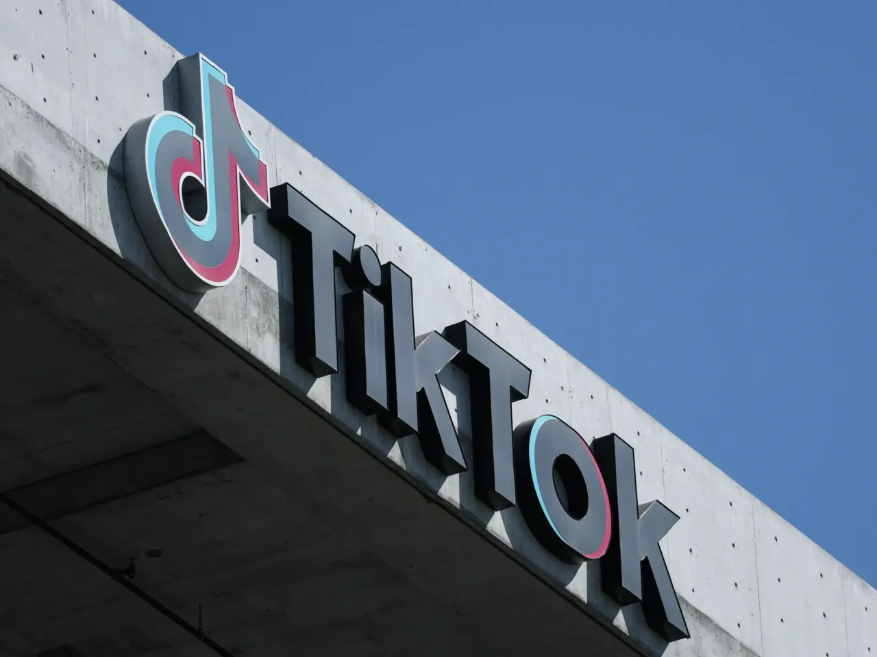 The TikTok logo is displayed on signage outside TikTok social media app company offices in Culver City, California on September 30, 2025. A new law in Virginia is designed to limit social media use by kids under 16 to one hour a day. It faces a legal challenge.