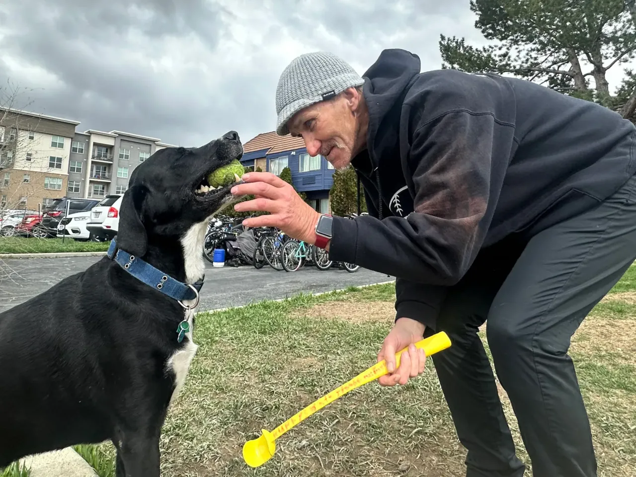 Jeff Gregg plays fetch with his dog, Ruffy, outside the MVP Shelter in Sandy, Utah. He says the specialized medical services helped him stop using opioids and get surgery for chronic back pain. He hopes that this will allow him to get a job and afford an apartment.