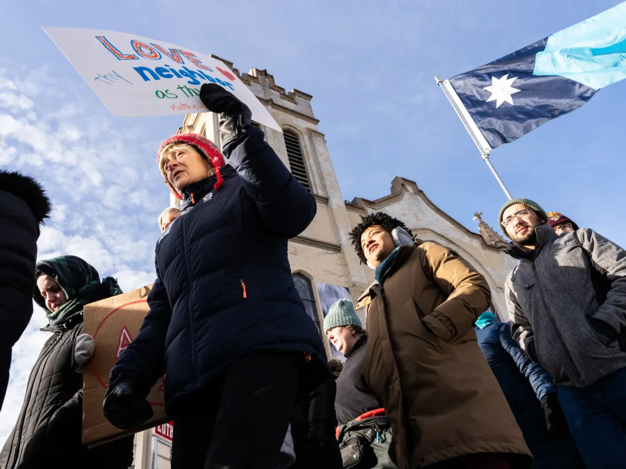Participants in a singing vigil leave St. Paul's-San Pablo Lutheran Church before marching around the Phillips neighborhood in Minneapolis Sunday, Jan. 11, 2026.
