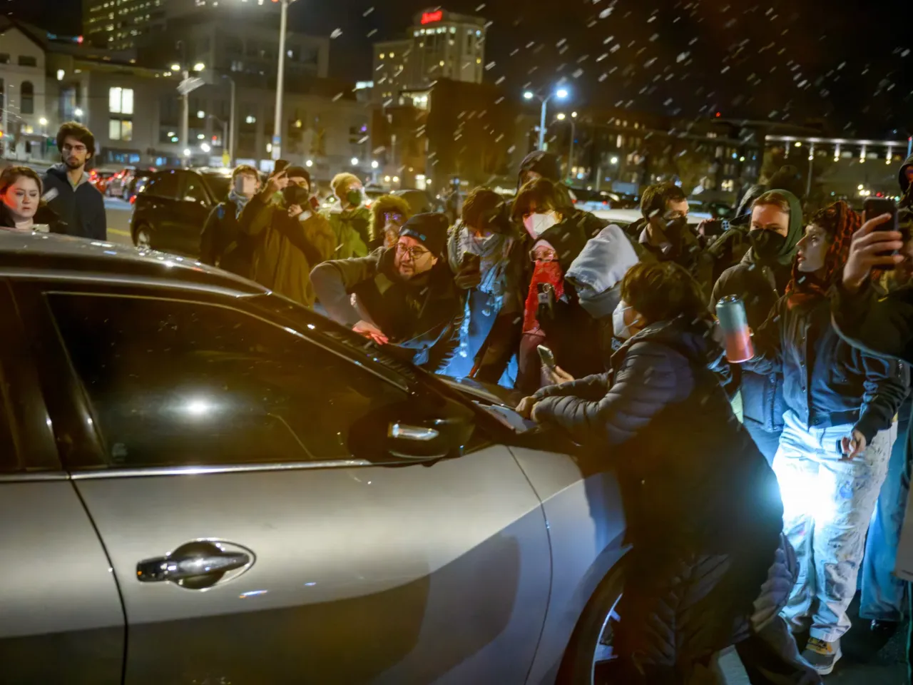 Protesters block a car as it exits Hartford's Federal Building on Jan. 8.