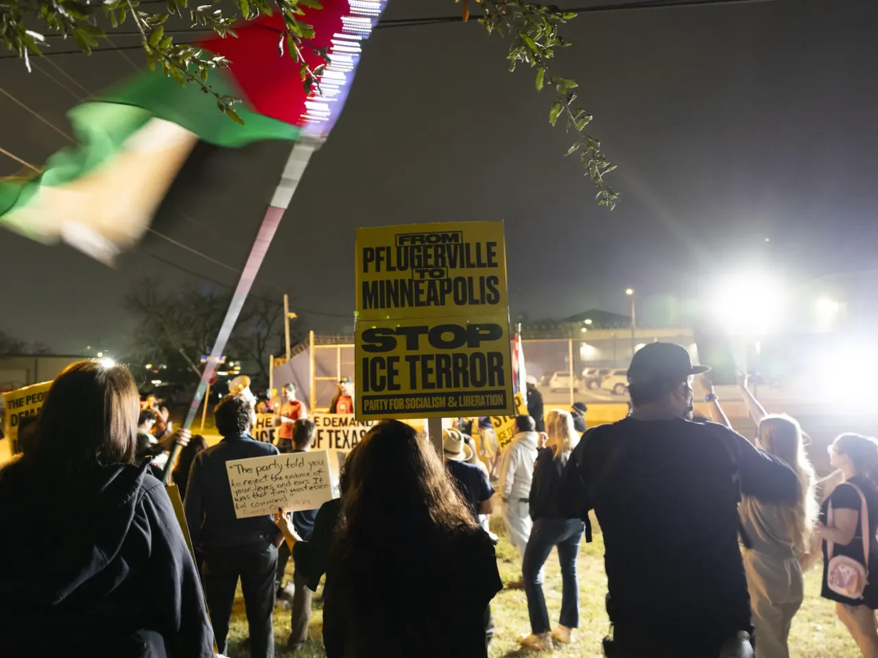 Protesters hold signs in front of the U.S. Department of Homeland Security building in Pflugerville, Texas on Jan. 8, 2026. The protest, organized by the Austin chapter of the Party for Socialism and Liberation, came after an ICE agent shot and killed Renee Macklin Good in Minneapolis, Minn., the day before.