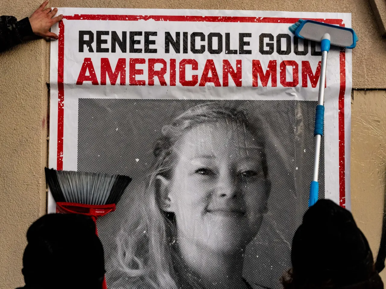 Activists paste posters of Renee Macklin Good outside of a building on Lyndale Ave. in Minneapolis on Sunday, Jan. 11, 2026.
