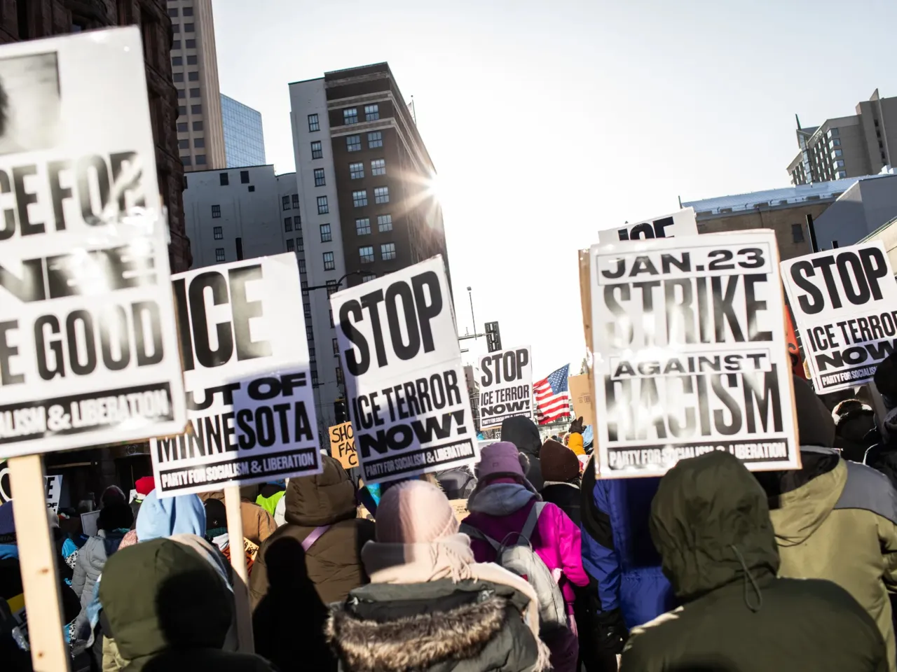 Minnesotans turn out in the frigid cold to protest Trump's immigration crackdown 2 Protesters hold signs demanding justice for Renee Good, who was killed by an ICE agent, and calling to stop ICE operations in Minneapolis, Minn., Jan. 23, 2026.